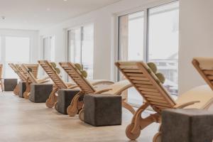 a row of chairs in a room with windows at FIRSTpeak Zauchensee in Zauchensee