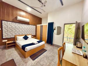 a bedroom with a bed and a desk and a window at Urban Villa in Guwahati