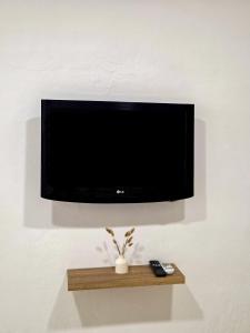 a flat screen tv hanging on a wall at Lithos Home Agia Galini in Agia Galini
