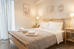 a bedroom with a bed with towels on it at Mika's Loft - Pylos in Pylos
