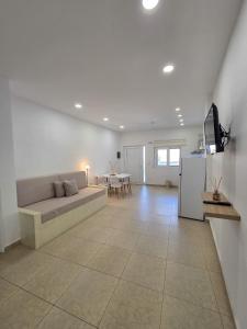 a living room with a couch and a table at Lithos Home Agia Galini in Agia Galini