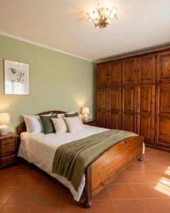 a bedroom with a bed and a chandelier at Casa Corbella in Magnano
