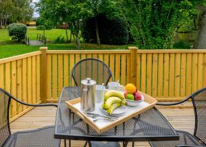 a tray of fruit on a table on a patio at Ashlea Pools Lodges in Hoptonheath