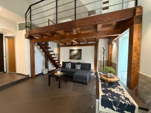 a living room with a couch and a loft at CasaCastellett in Modica +24 photos