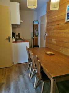 a dining room with a wooden table and chairs at Appartement Cauterets in Cauterets