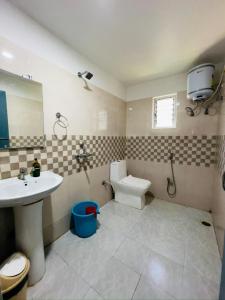 a bathroom with a sink and a toilet at Urban Villa in Guwahati +31 photos