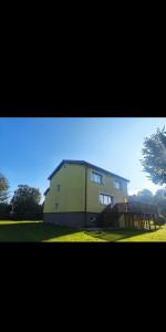 a large house is sitting in the grass at Dom Na Fali in Pasym