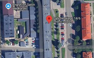 a map of a parking lot with a red marker at Sleep & Chill in Leszno