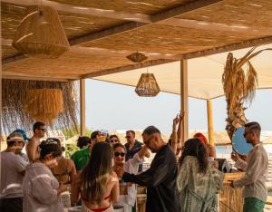 a crowd of people standing under a tent at Koi otel in Ayvalık