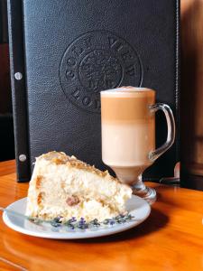 a piece of cake on a plate next to a cup of coffee at Golf View Lodge Melmoth in Melmoth