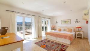 a bedroom with a bed and a large window at TEKCE Villa Dolly N24 in Kalkan +26 photos
