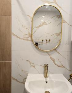 a bathroom with a sink and a mirror on the wall at Panorama Sunset Studio in Stara Zagora +15 photos