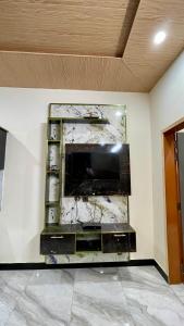 a flat screen tv on a wall in a room at 1 Bed Apartment with View in Patriata