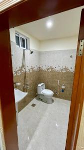 a bathroom with a toilet and a sink at 1 Bed Apartment with View in Patriata
