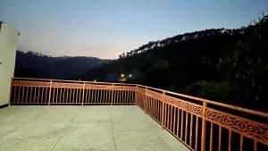 a wooden balcony with a view of a mountain at 1 Bed Apartment with View in Patriata