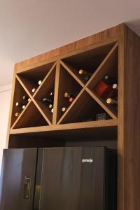 a wine cabinet with a bunch of wine bottles at Apartman Centar in Teslić