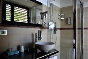 a bathroom with a bowl sink and a shower at Hotel Cala Luna in Cala Gonone +37 photos