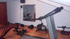 a room with a gym with a treadmill and weights at Hotel Corneliuss in Galaţi