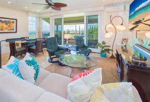 a living room with a white couch and a table at 622 Kapalua Ridge Villa in Lahaina