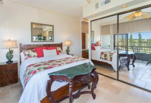 a bedroom with a large bed and a balcony at 622 Kapalua Ridge Villa in Lahaina