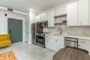 a kitchen with white cabinets and stainless steel appliances at Park Hotel Studio Suite 507 in Chattanooga +26 photos