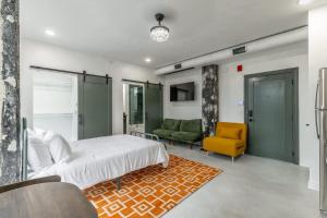 a bedroom with a bed and a couch and a chair at Park Hotel Studio Suite 507 in Chattanooga