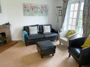 a living room with a couch and a chair at Castle House Cottage in Horton