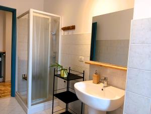 a bathroom with a sink and a mirror and a shower at CASA IUCCI Langhe Monferrato in Canelli