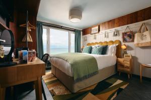 a bedroom with a large bed and a window at Pedn-Olva in St Ives
