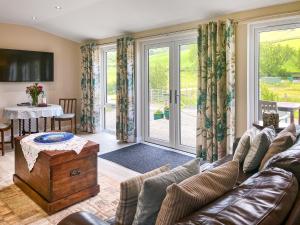 a living room with a couch and a table at Ridge View Lodge - Uk49924 in Dumfries
