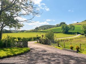 a dirt road in a field with a fence at Ridge View Lodge - Uk49924 in Dumfries