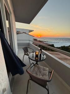 a balcony with a table and chairs and the ocean at Beachfront Studio with Panoramic Sea View 2 in Ialysos