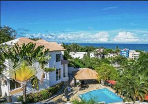 an aerial view of a house with a swimming pool at villa la dueña in San Felipe de Puerto Plata