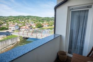 a balcony with a view of a bridge at Apartman Centar in Teslić