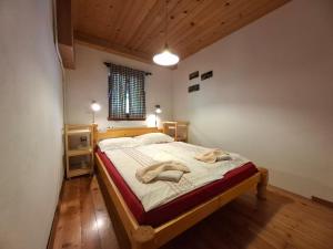 a bedroom with a bed with two towels on it at River House Mojstrana in Mojstrana
