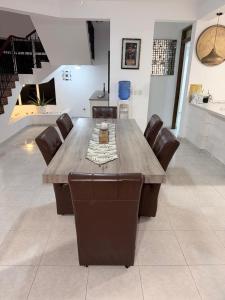 a dining room table with leather chairs and a tableasteryasteryasteryasteryasteryastery at villa la dueña in San Felipe de Puerto Plata