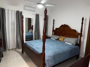 a bedroom with a bed and a mirror at villa la dueña in San Felipe de Puerto Plata +54 photos