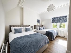 a bedroom with two beds and a window at Chowdene Lodge Estate in Gateshead