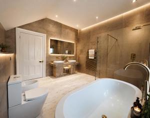 a bathroom with a tub and a toilet and a sink at Chowdene Lodge Estate in Gateshead