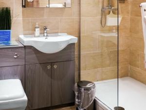 a bathroom with a sink and a shower at One The Old Stables in Knitsley