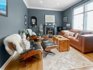 a living room with a couch and chairs at Taigh Beag in Stranraer