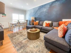 a living room with a couch and a table at Taigh Beag in Stranraer