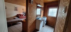 a small bathroom with a sink and a washing machine at Chez Chou-Vrac & Ciboulette in Durbuy