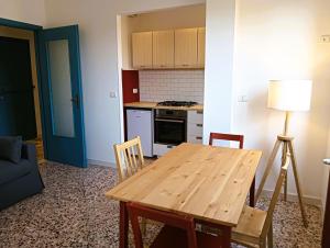 a kitchen with a wooden table and a stove top oven at CASA IUCCI Langhe Monferrato in Canelli