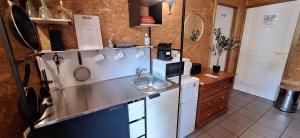a kitchen with a sink and a counter top at Chez Chou-Vrac & Ciboulette in Durbuy