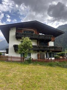 a house with a fence in front of it at Katja's Loft in Neustift im Stubaital