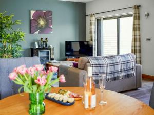 a living room with a table and a couch at Three The Old Stables in Knitsley