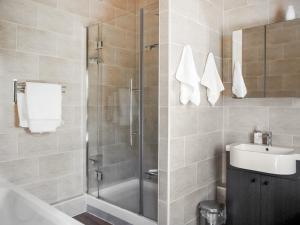 a bathroom with a shower and a sink at Three The Old Stables in Knitsley