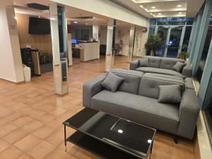 a living room with a couch and a coffee table at Regina Goren Hotel in Ashkelon