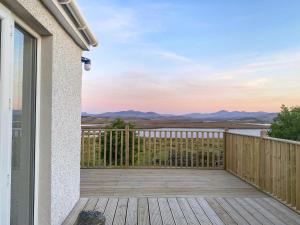 a balcony with a view of the water at Go Ye Cottage in Leurbost